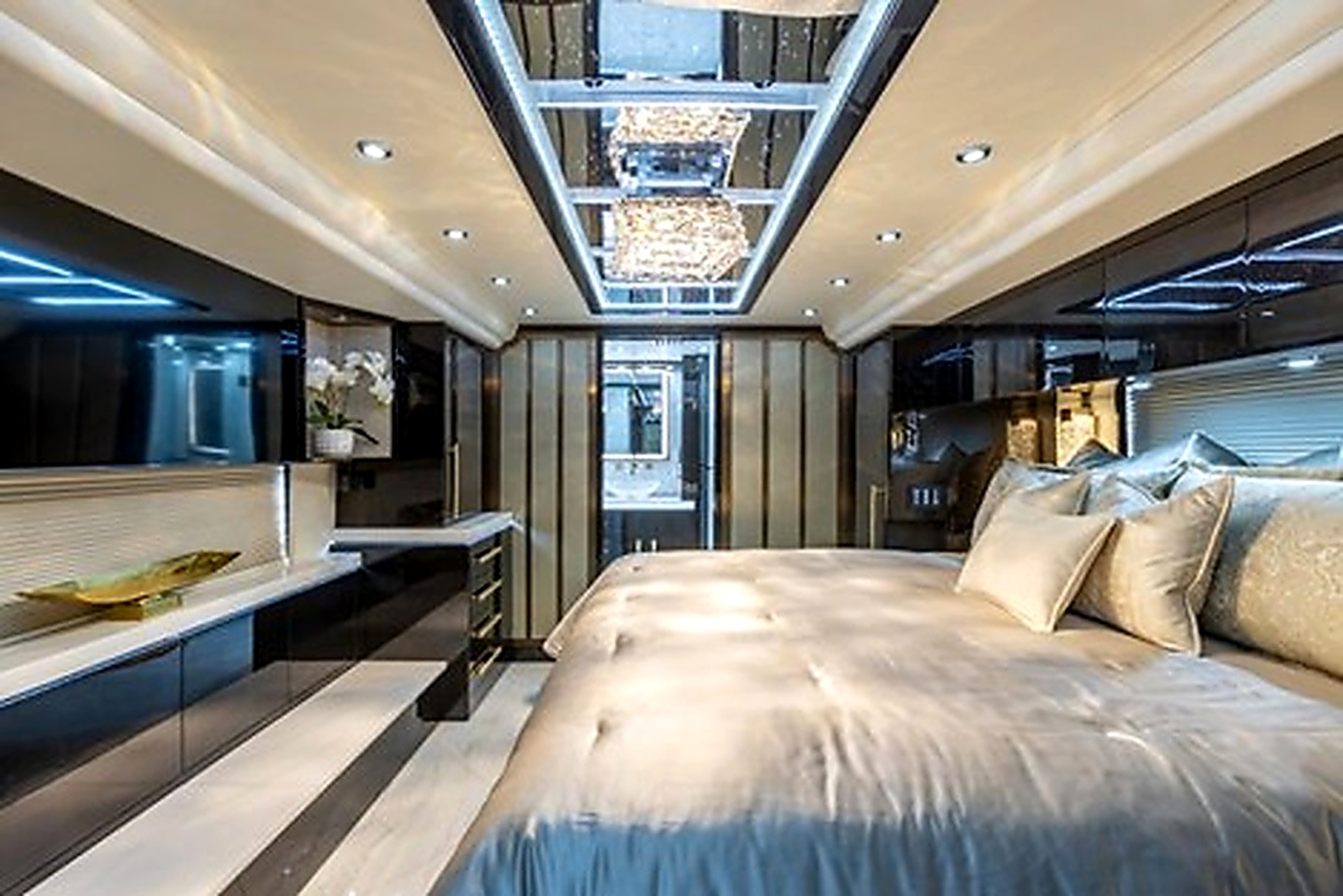 Prevost master suite bedroom with crystal chandelier